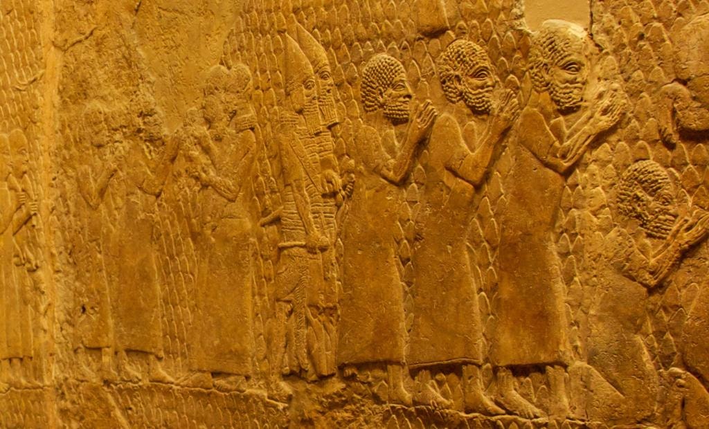 Close-up detail of kneeling Judahite captives from the Lachish Relief showing tightly-coiled woolly hair